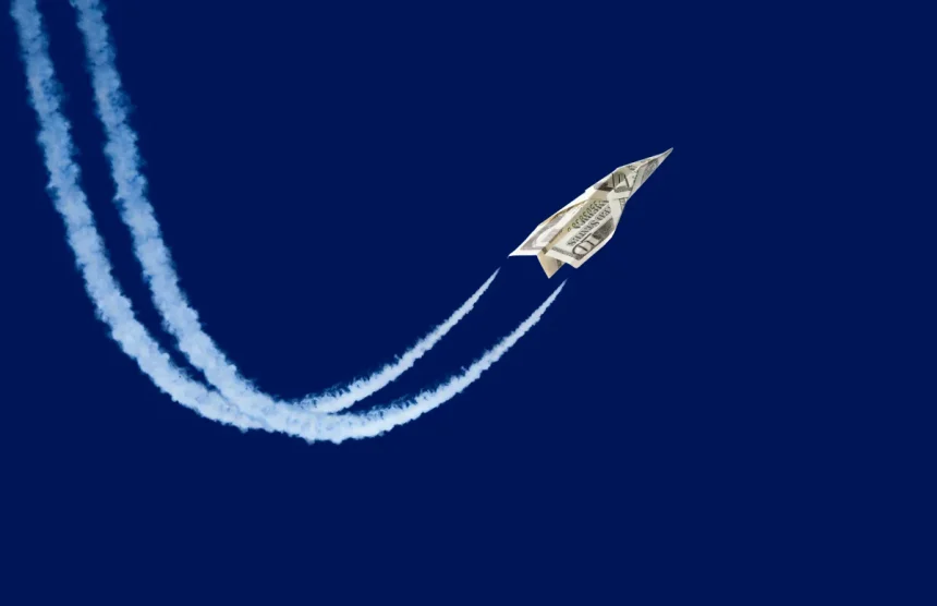 paper plane made from a ten-dollar bill