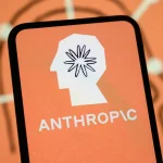 The Anthropic logo is displayed on the screen of a smartphone with the company