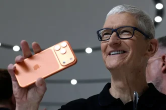 Apple CEO Tim Cook holds up a new iPhone 17 Pro