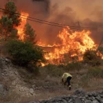 Wildfires in Catalonia close major roads and suspend train services, disrupting travel to Spain