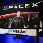 SpaceX CEO Elon Musk, displayed on a screen remotely from SpaceX headquarters in Starbase, Texas, speaks before the launch of SpaceX’s initial public offering (IPO) at the Nasdaq MarketSite in New York on June 12, 2026.