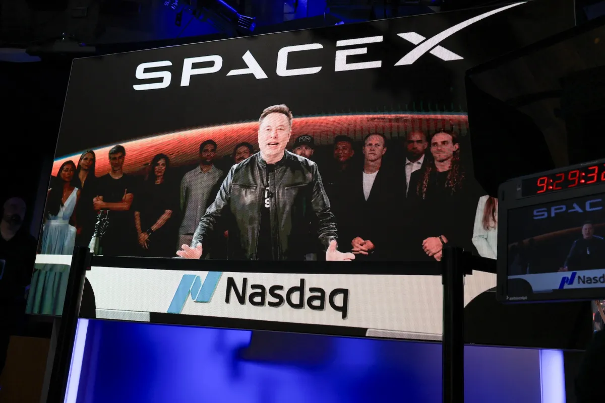 SpaceX CEO Elon Musk, displayed on a screen remotely from SpaceX headquarters in Starbase, Texas, speaks before the launch of SpaceX’s initial public offering (IPO) at the Nasdaq MarketSite in New York on June 12, 2026.
